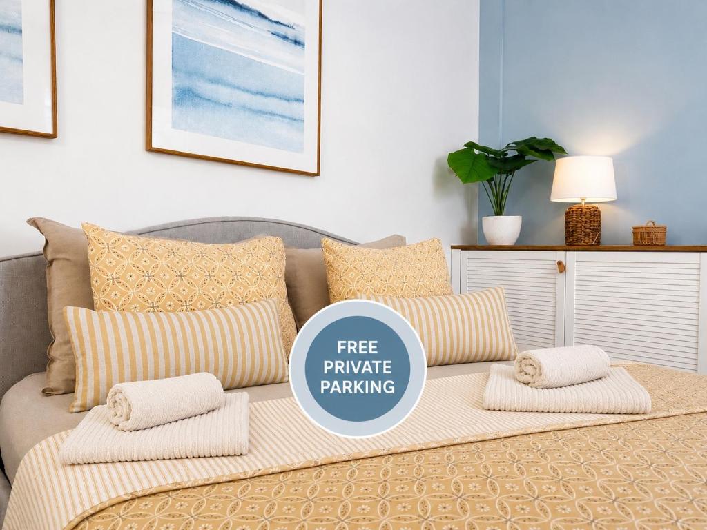 a couch with pillows and a sign that says free pineapple parking at SEAESTA Cosy Sea Apartment in Koper