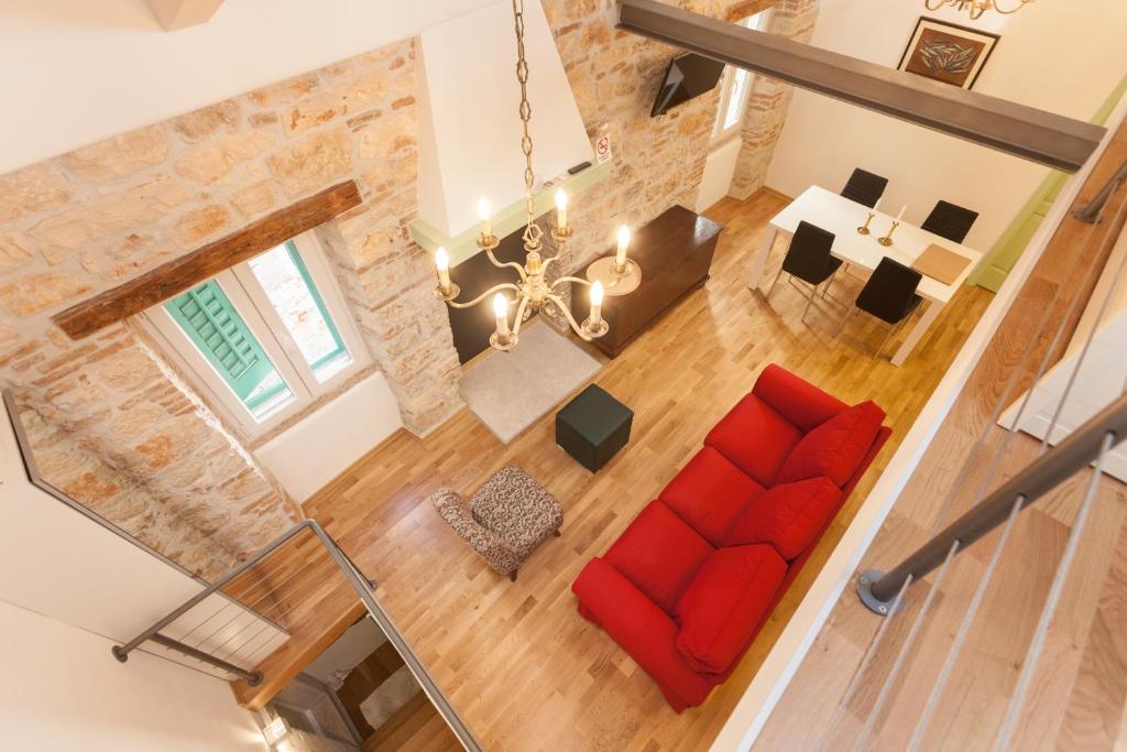an overhead view of a living room with a red couch at Apartment Amare in Rovinj