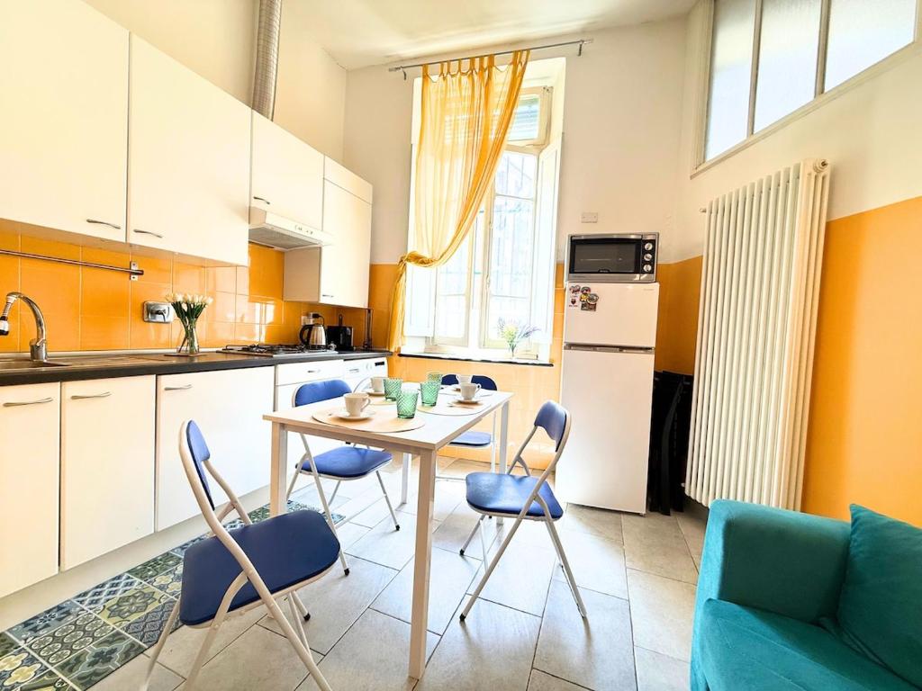 a kitchen with a table and chairs in a room at DIMORA Concept - Yellow Apartment in Ceriale