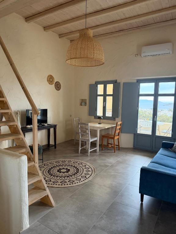 a living room with a table and a dining room at Casa Luca in Drios