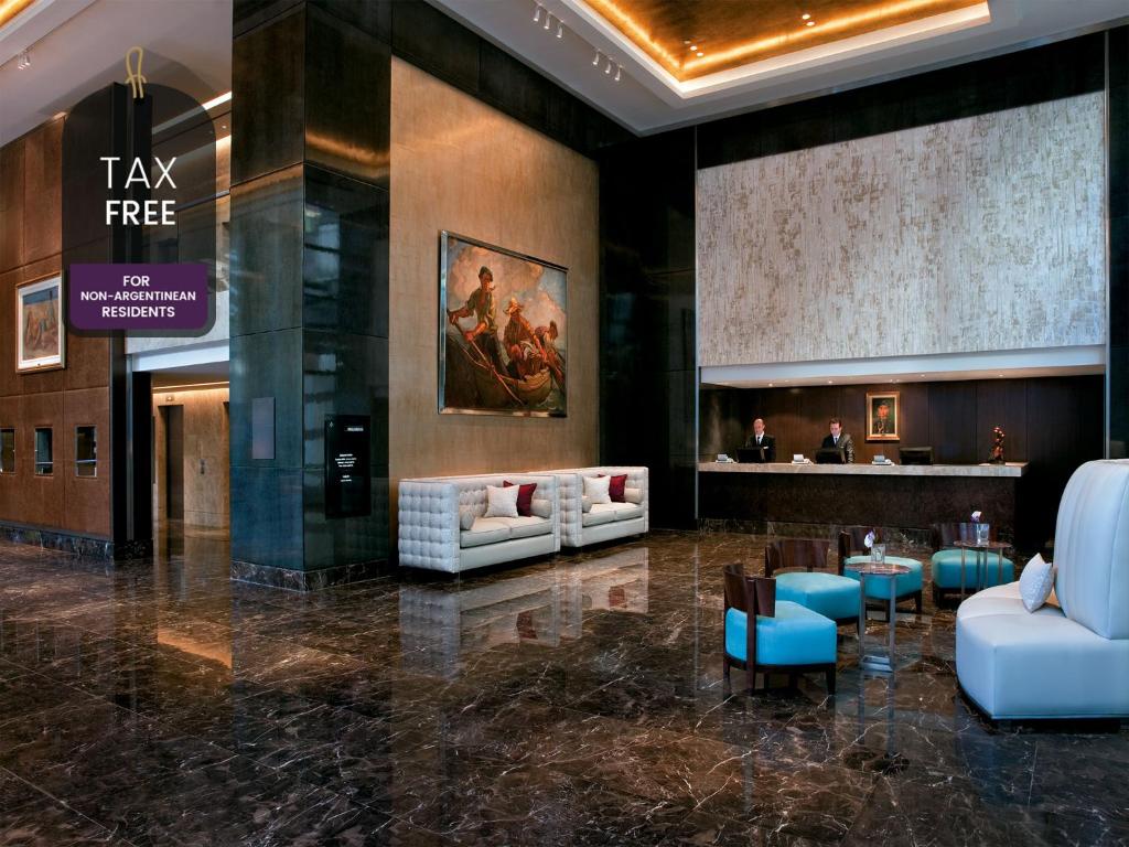 a lobby with couches and tables in a building at Alvear Art Hotel in Buenos Aires