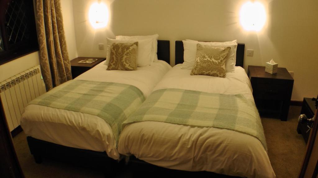 two twin beds in a hotel room at Bay Lodge in Birchington