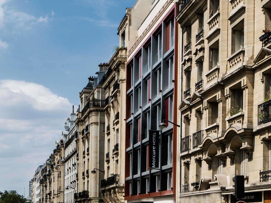 a row of tall buildings on a city street at Mercure Paris 17 Batignolles in Paris