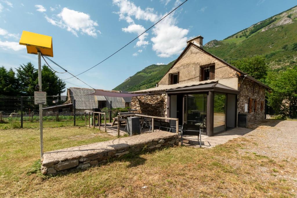 an old stone house in a field at Grange des 2 Cols - Jacuzzi - Jardin in Campan