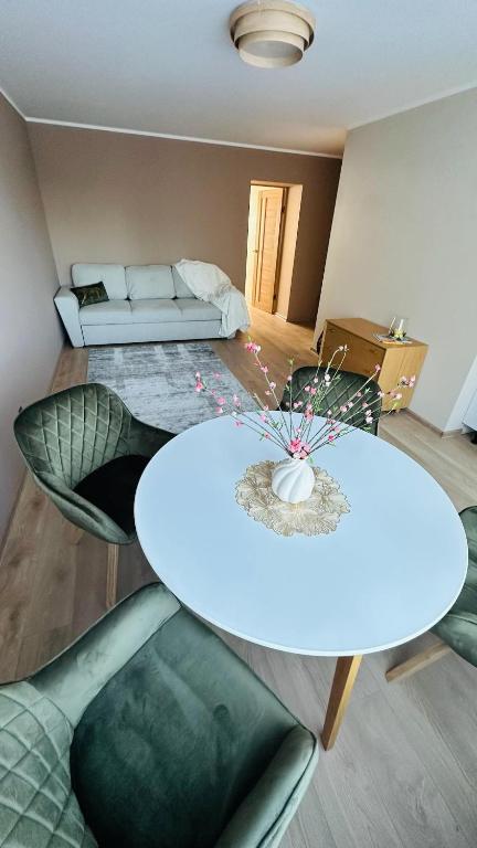 a living room with a table and chairs and a couch at Peaceful haven in Liepāja
