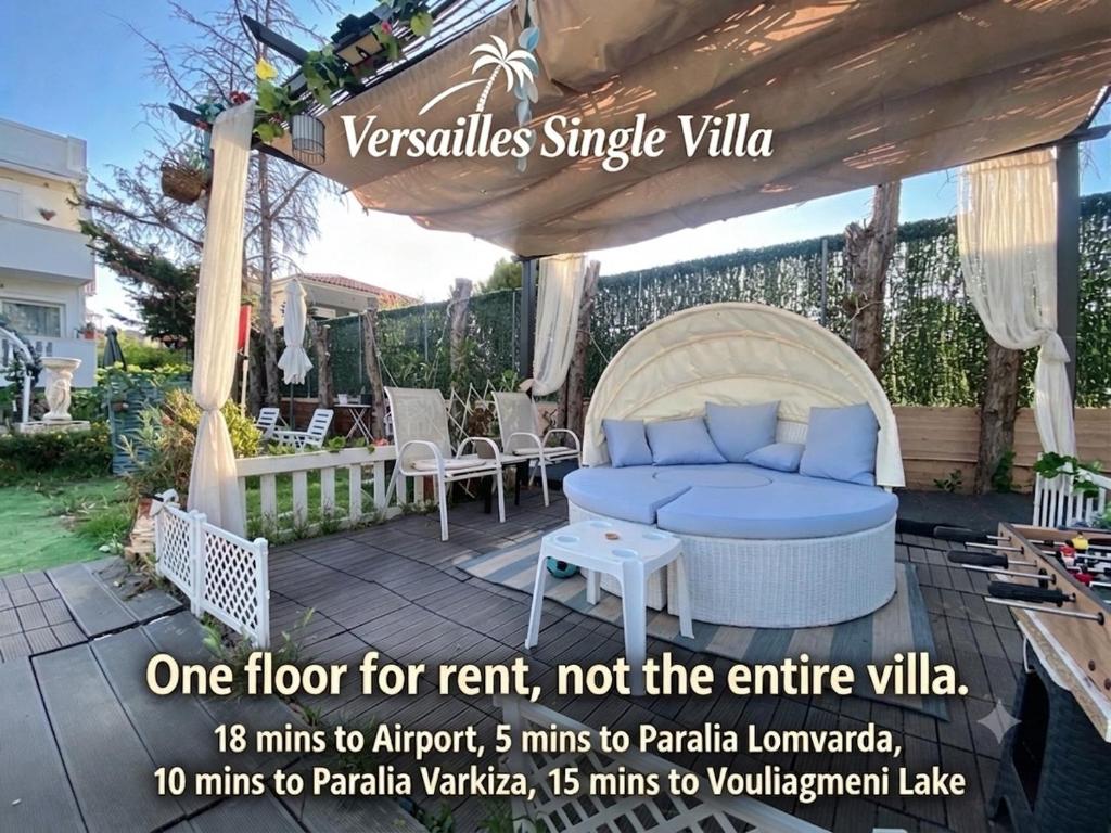 a pergola with a blue couch on a patio at Versailles One Villa one-story suite in Metókhi