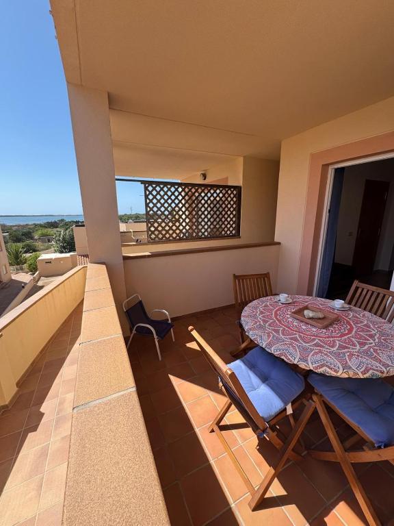 a room with a table and chairs on a balcony at Espalmador E10, RT259PL in Es Pujols