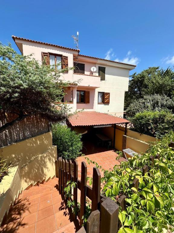 a house with a fence in front of it at Le Case dei Ginepri in Marina di Sorso