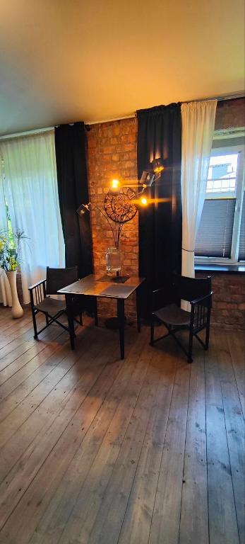 a dining room with a table and chairs in a room at Kipsala Cozy Apartment in Riga