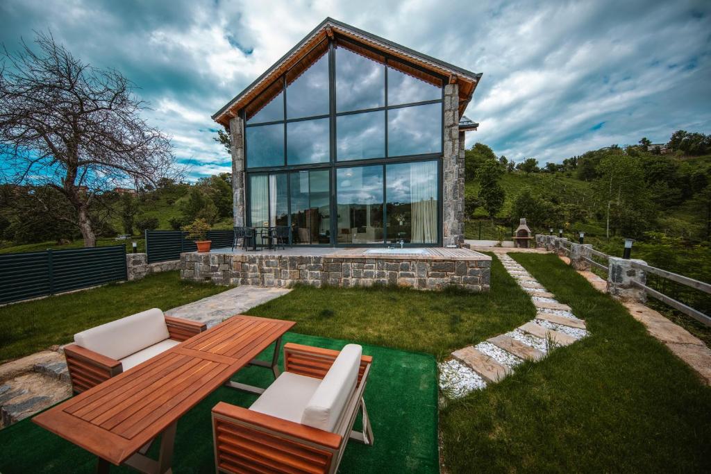 a house with a table and chairs in the grass at Sky Line Villa in Ardeşen