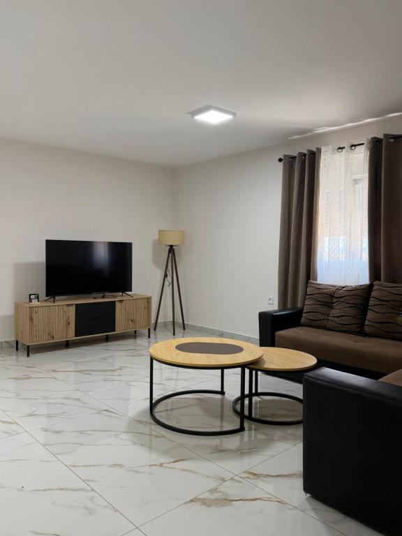 a living room with a couch and a table at Apartmani Kastratovic in Golubovci