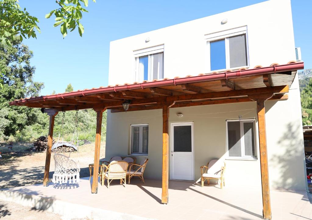 a pergola on a patio in front of a house at Kritharistra Home in Vlakhiá