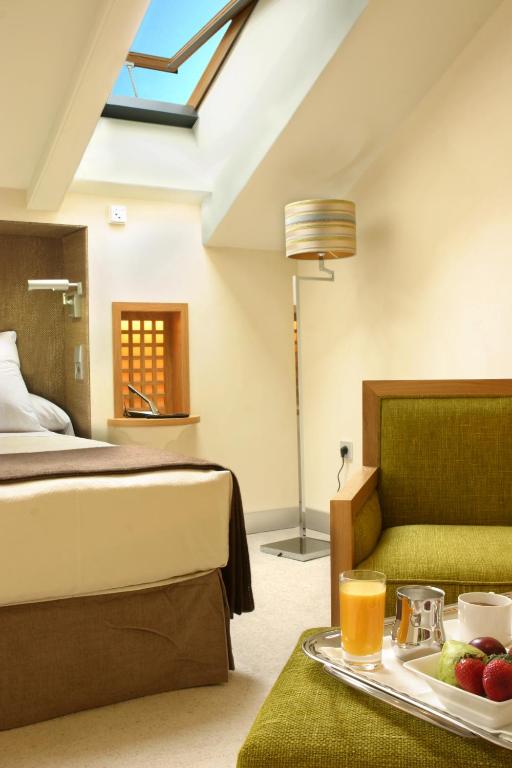 a hotel room with a bed and a tray of food at Villa Oniria in Granada