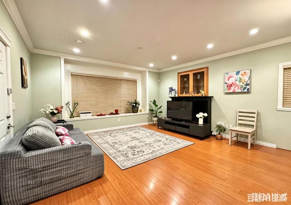 a living room with a couch and a television at 3BR Spacious Living Space 1 Parking Private Entry in Richmond