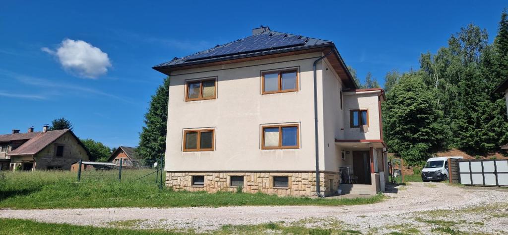 a large white house with a black roof at Nová Paka 1402 in Nová Paka