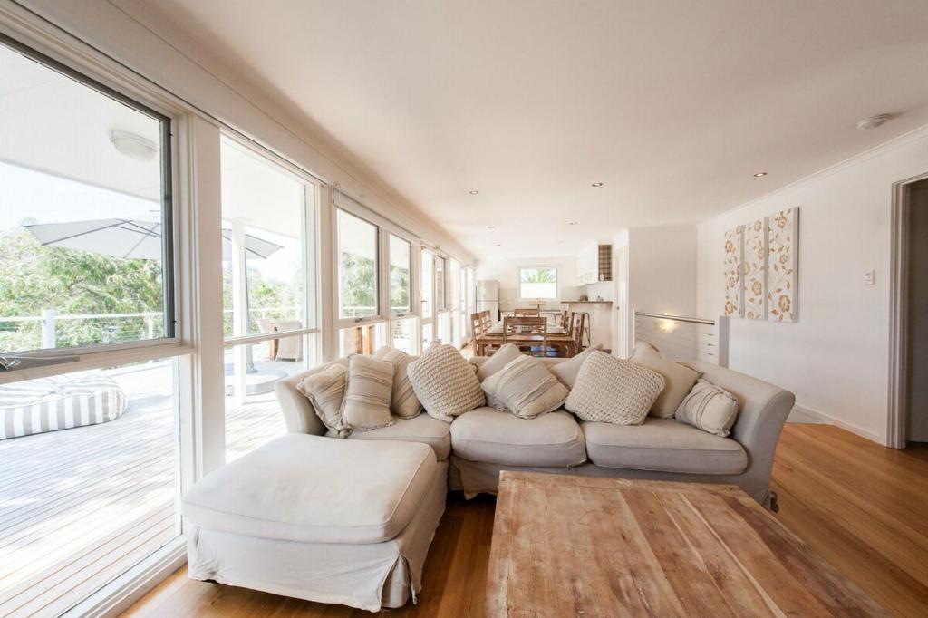 a living room with a couch and a table at Bella Vita Beach House in Robe