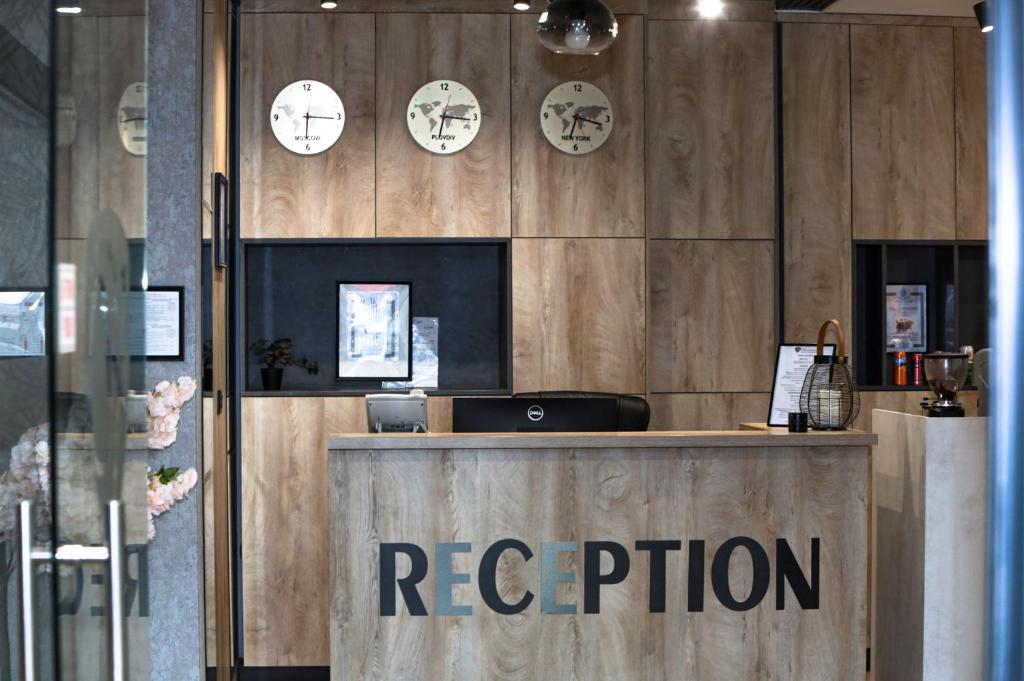 a reception area with clocks on the wall at Philippopolis Hotel in Plovdiv