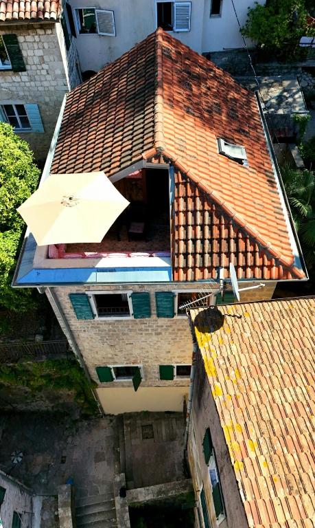 an overhead view of a building with an umbrella at Mediterranean Stone Villa in Old Town in Kotor