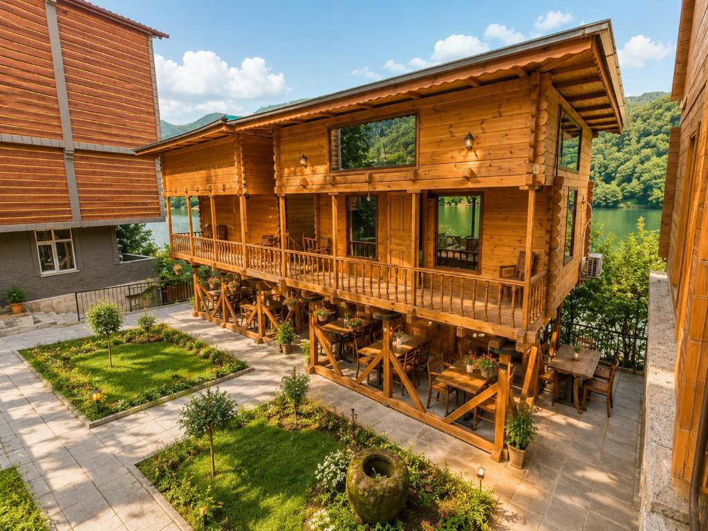 an aerial view of a log cabin with a deck at Buneba Resort in Borçka