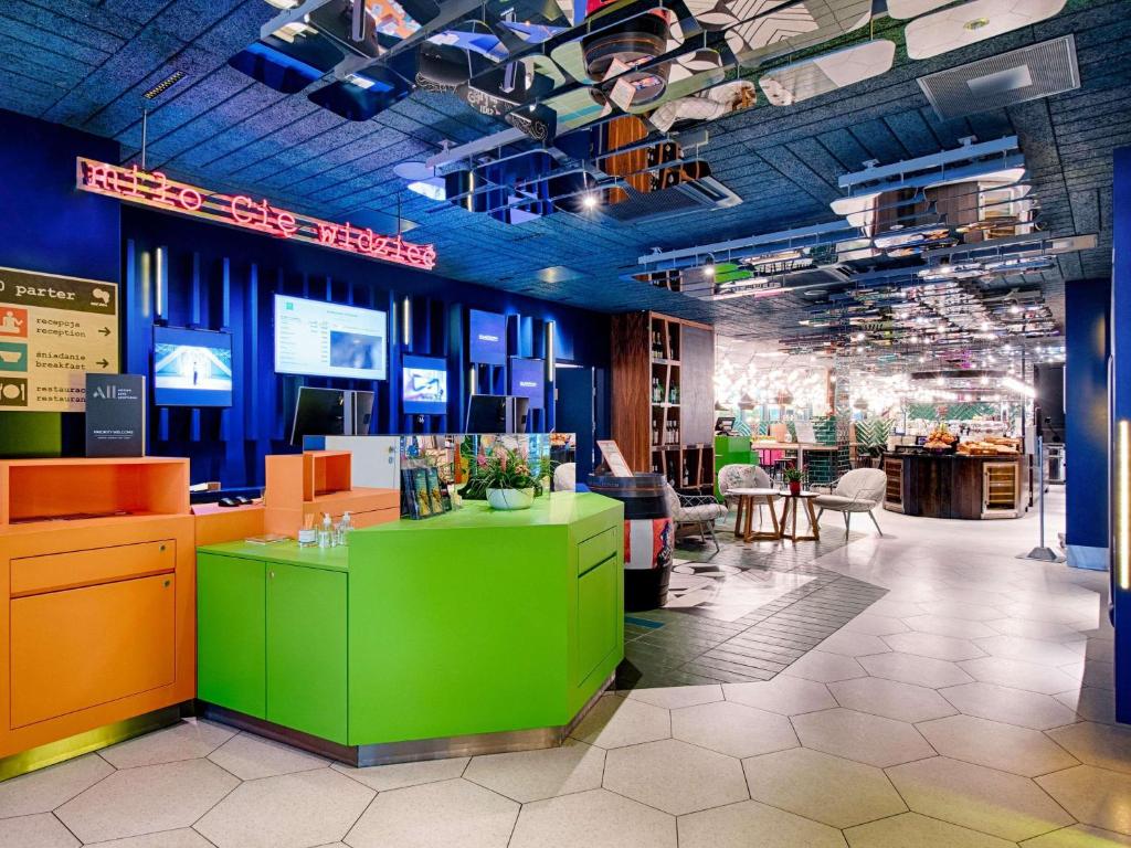 a store with a green counter in a room at ibis Styles Warszawa Centrum in Warsaw