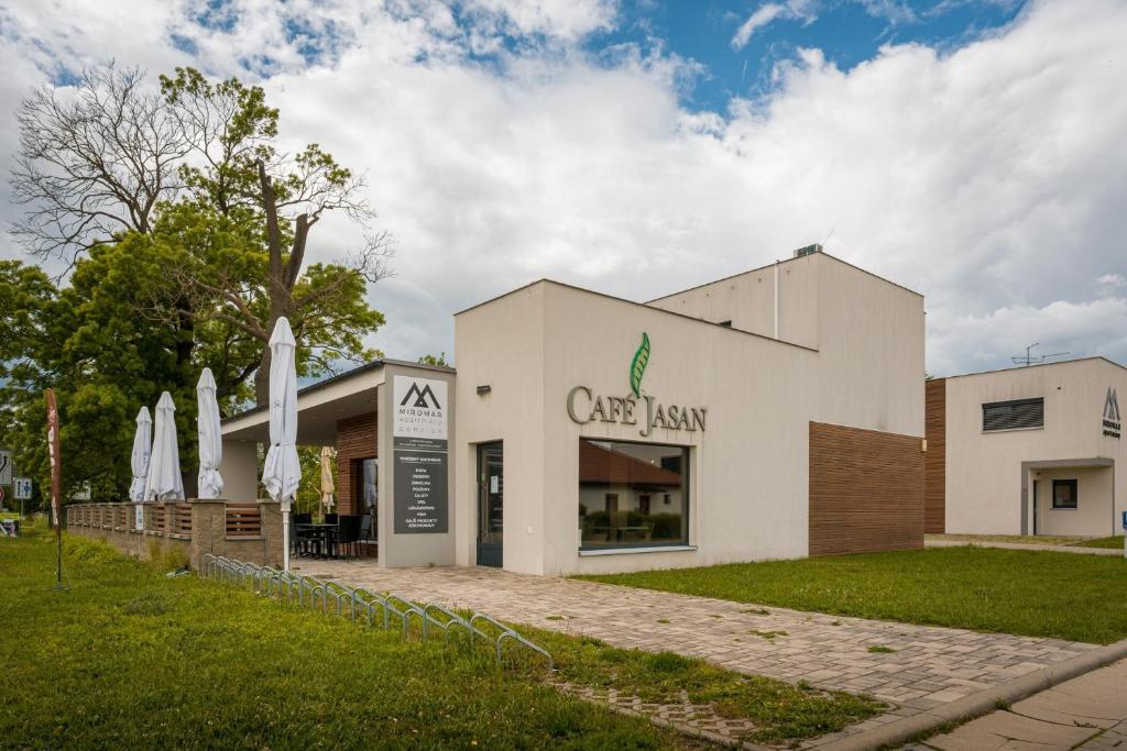 a white building with a sign on the front of it at Apartmány Miromar in Podivín