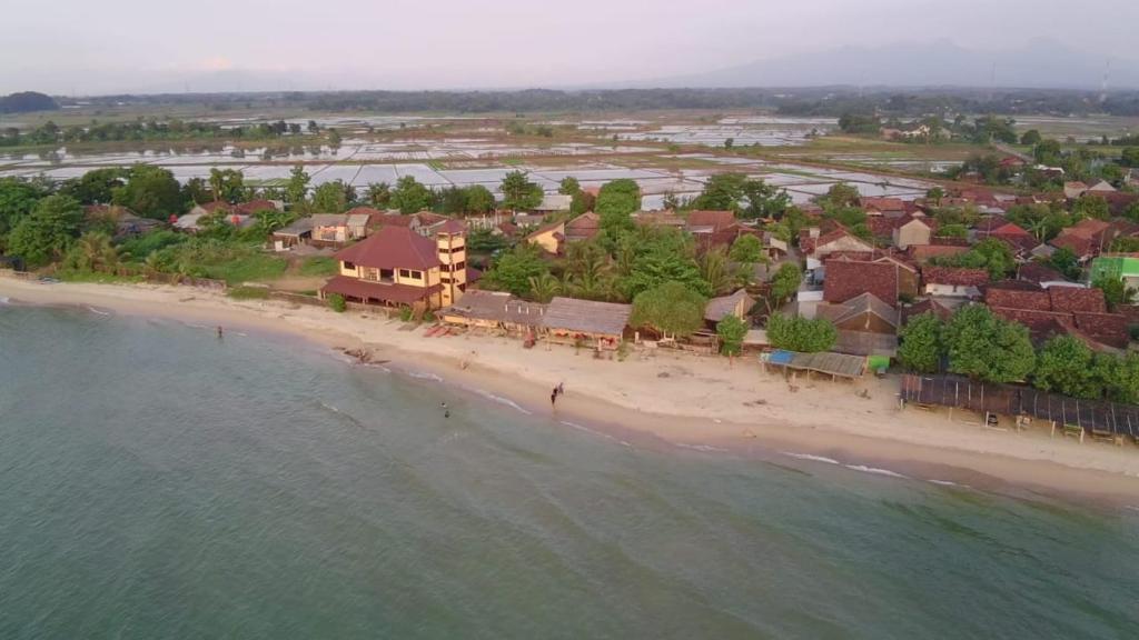 an aerial view of a resort on a beach at Omah Laut Bondo Jepara - by the beach, direct view of the sea, great base for water sports in Margokerto