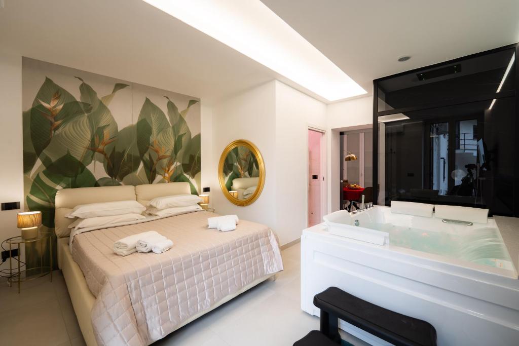 a bedroom with a bed and a bath tub at Tortugas B&B in Giarre