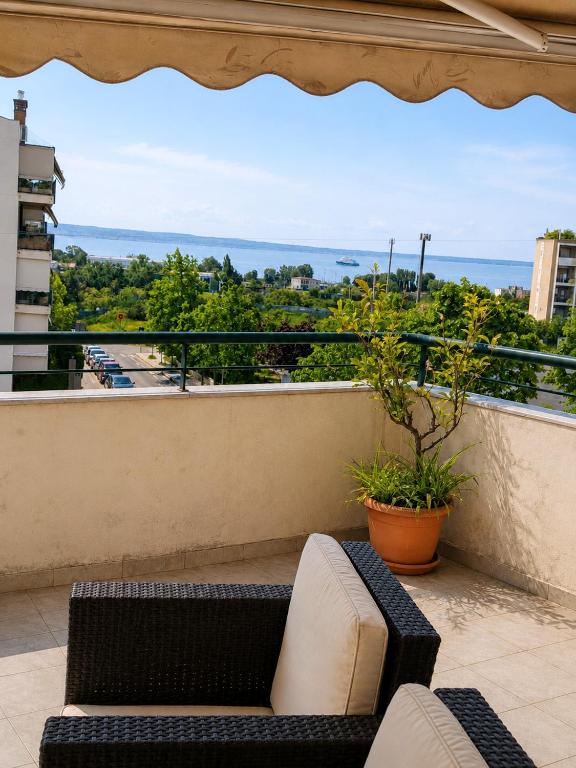 a balcony with a couch and a view at Blue Horizon SKG in Thessaloniki