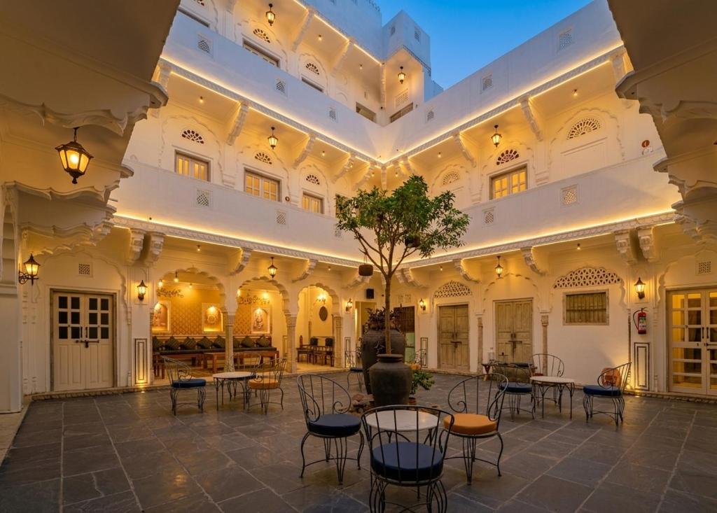 a courtyard with tables and chairs in a building at Sitaram Bhawan - A 250-Year- Old Heritage Haveli, Jaipur in Jaipur