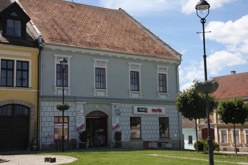 a white building with a red roof at Apartmány PAPÍK in Nová Bystřice
