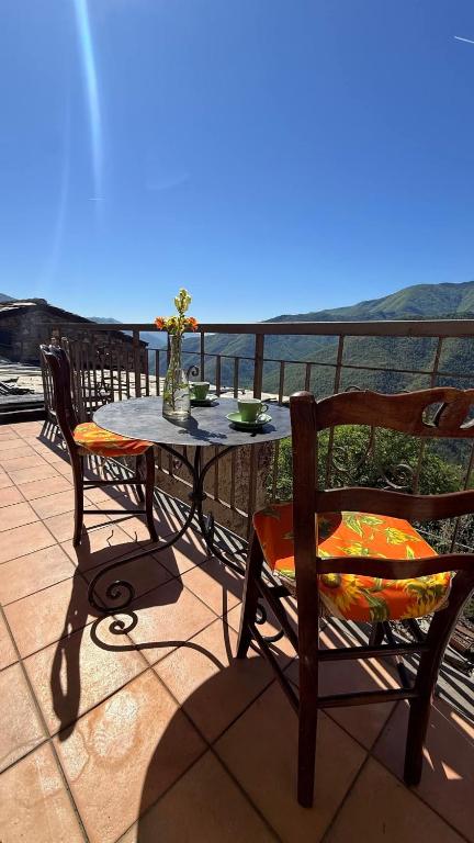 a table and chairs on a balcony with a view at Piano Piano Affittacamere in Andagna