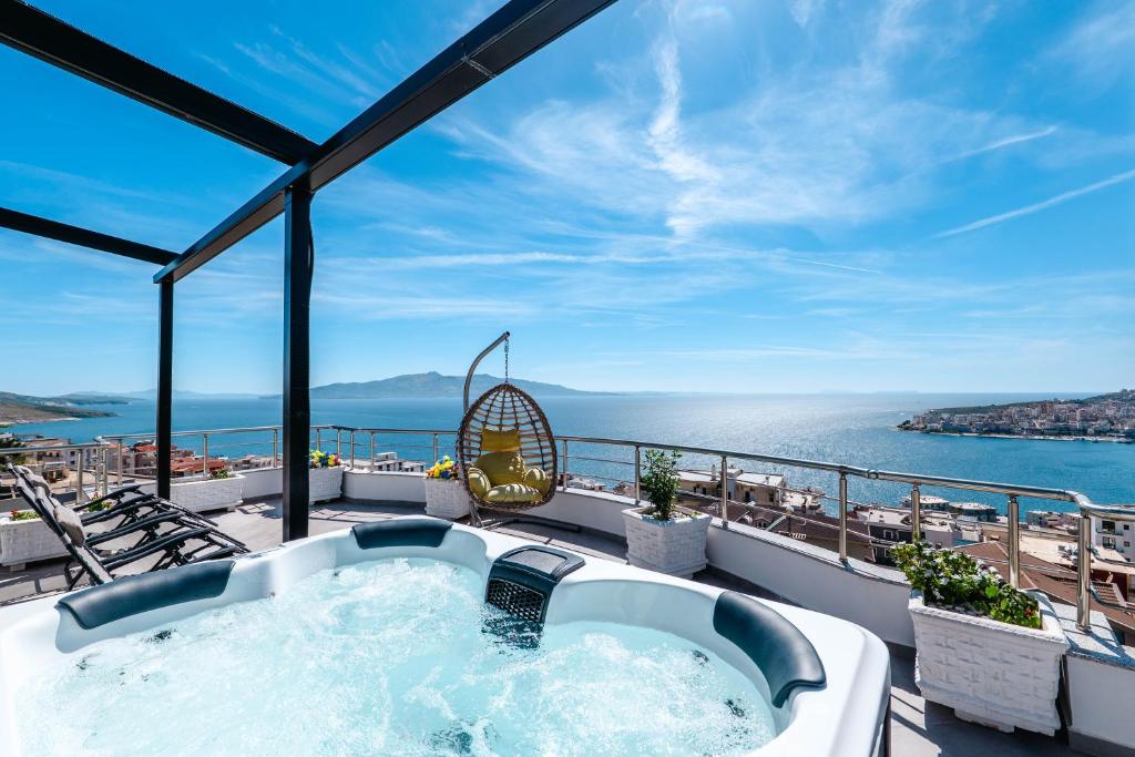 a hot tub on a balcony with the ocean at Eleni Guest House in Sarandë