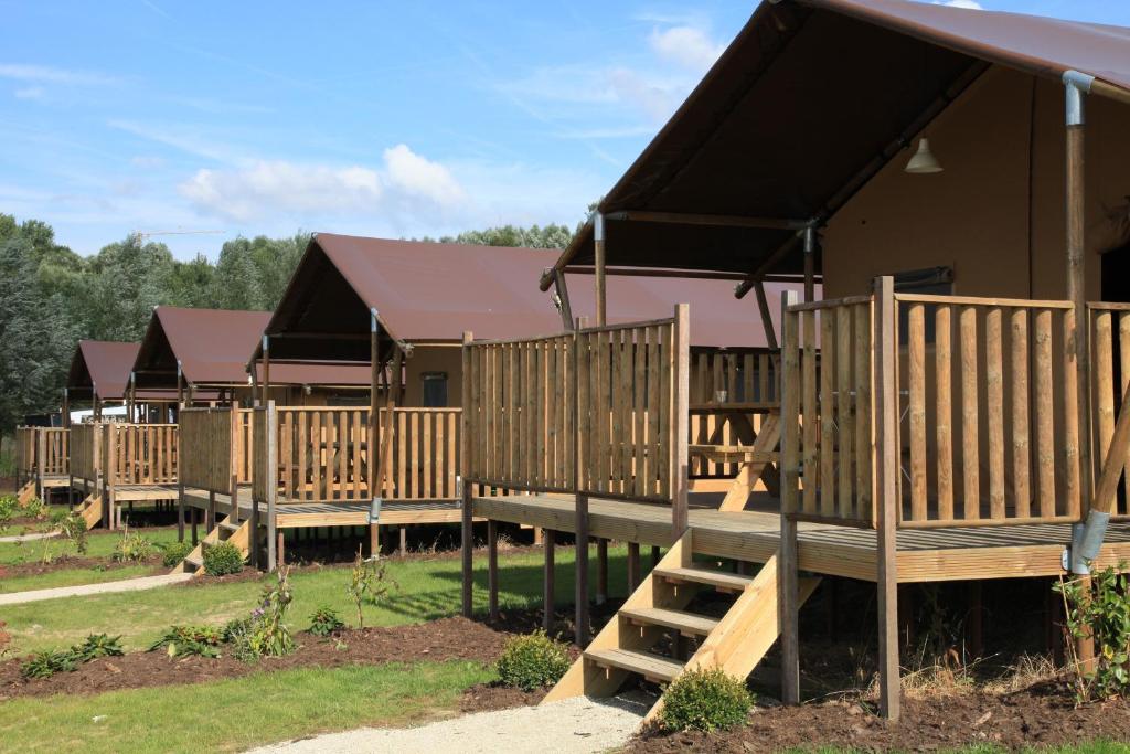 a row of wooden lodges in a park at Ijsmolenhoeve in Ronse