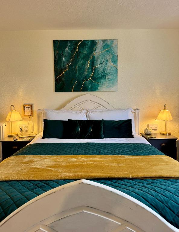 a bedroom with a large bed with two night stands at The Wadham in Weymouth