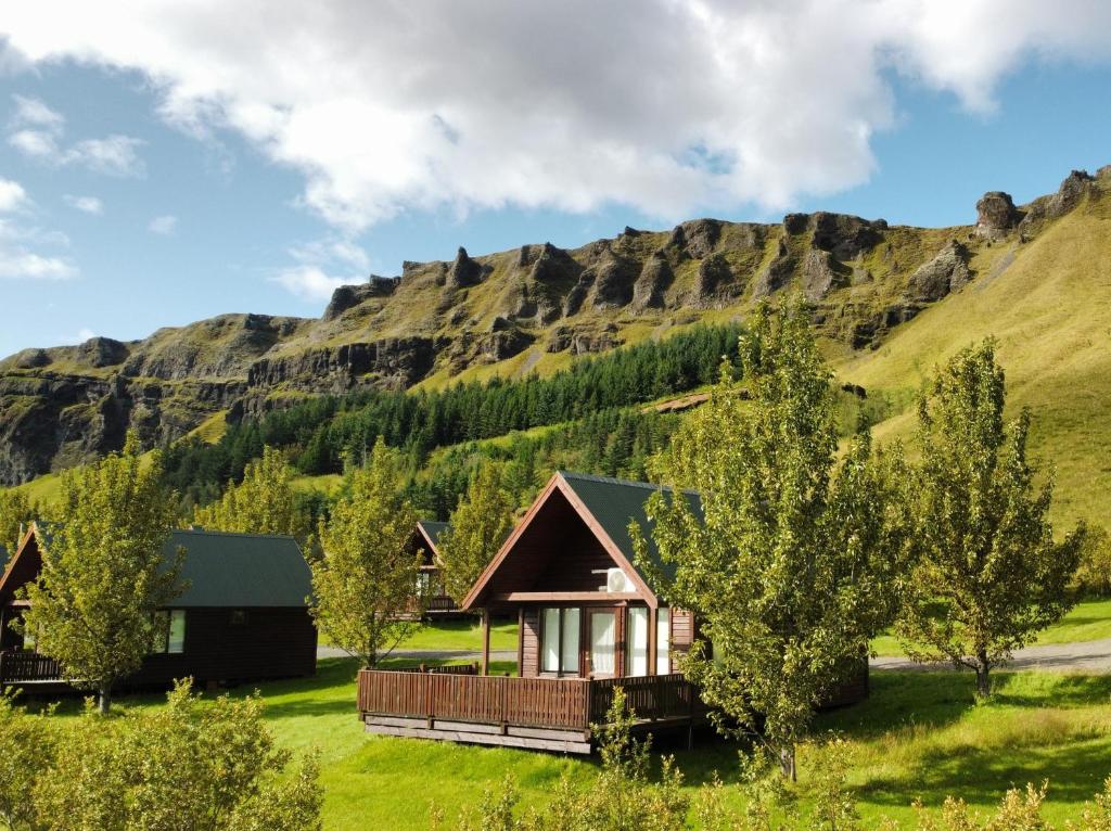 a cabin in front of a mountain at Hörgsland Cottages in Hörgsland