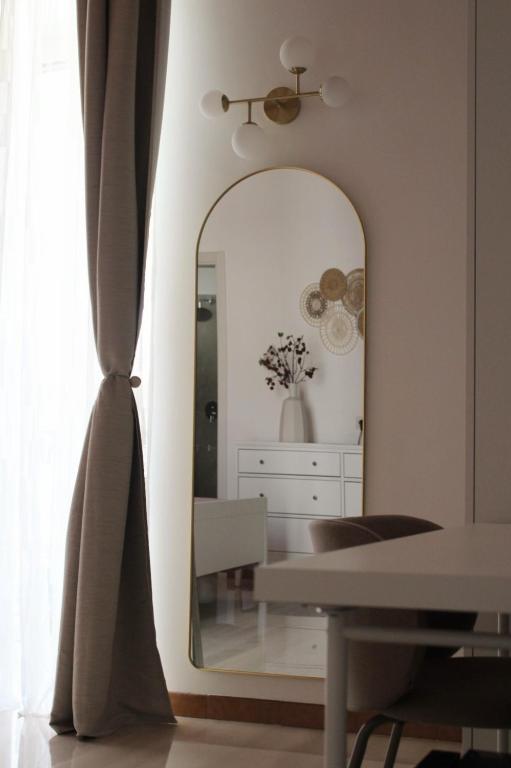 a living room with a mirror and a table at Dimora Letizia, Apulian Rooms in Sammichele di Bari
