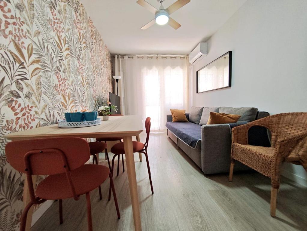 a living room with a table and a couch at Apartamento Puerta de Madrid 1 in Alcalá de Henares
