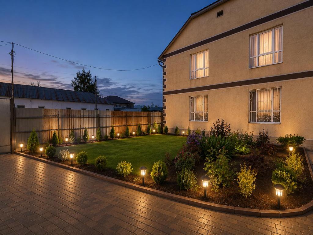 a courtyard of a house with lights in the yard at Guest house Nuri in Karakol