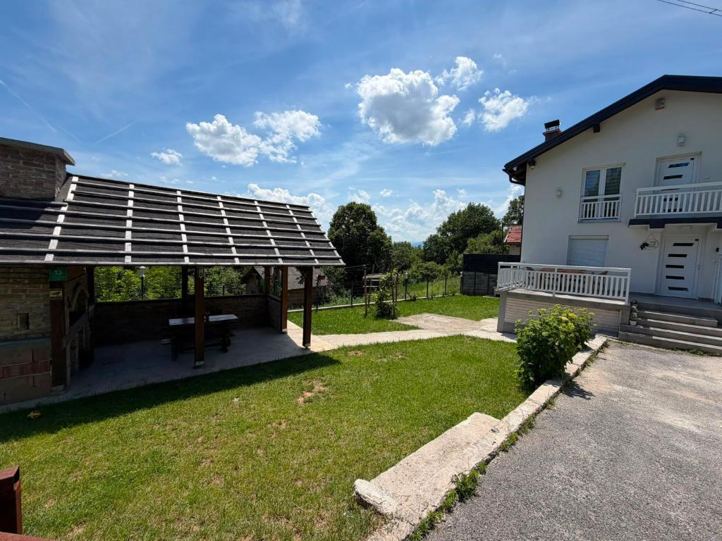 a house with a solar roof on a yard at Family Private House w Garden & Gazebo 10 Guests in Sarajevo
