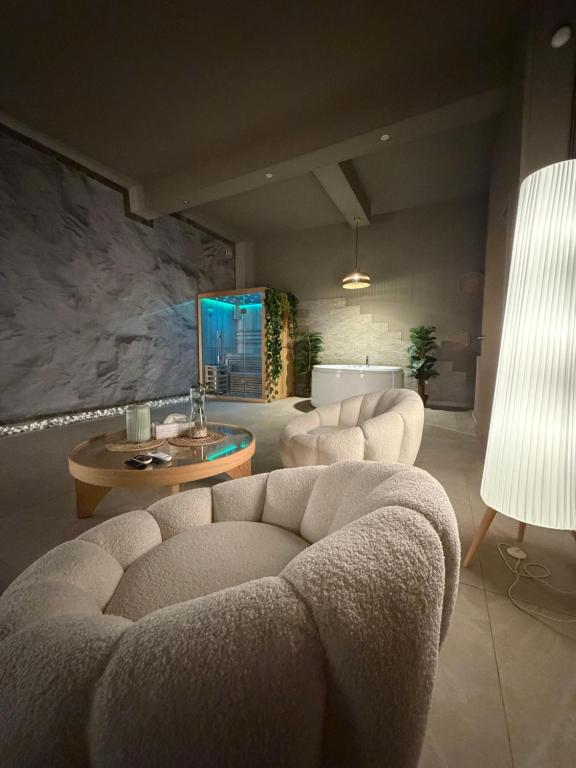 a living room with a couch and a table at BREATH47SPA - Private Spa Suite White Jacuzzi & Sauna in Marbella in Marbella