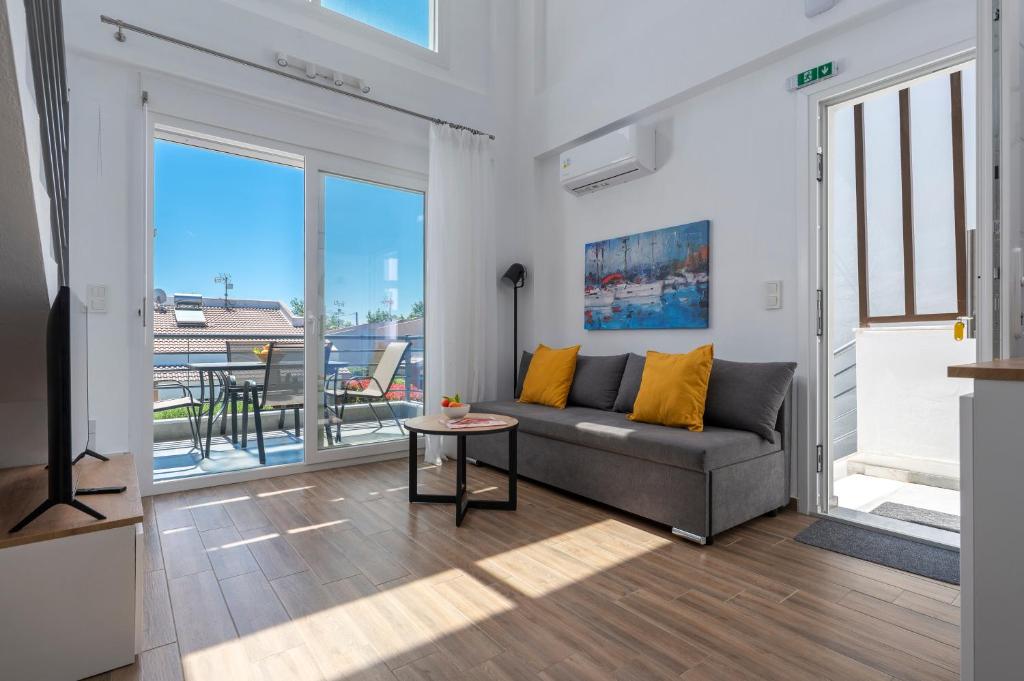 a living room with a couch and a table at SLV Irida Apartment in Ofrínion