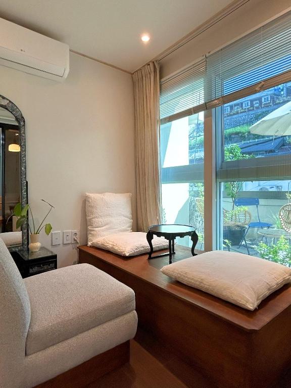 a room with a couch and a table and a window at Seoul Station ㅣThe interior of a hanok with a terrace in Seoul