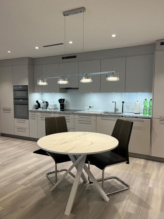 a kitchen with a table and chairs in a room at Cozy apartment in Zurich
