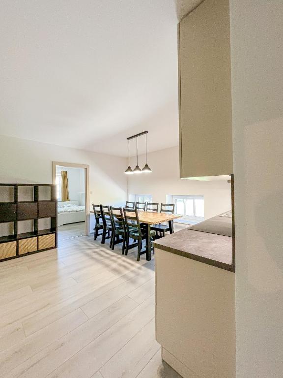 a kitchen and dining room with a table and chairs at Apartmán Proseč-Obořiště in Nová Cerekev