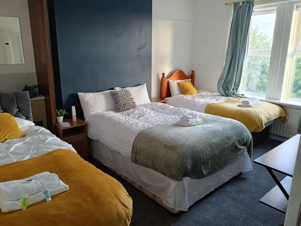 a bedroom with two beds with stuffed animals on them at Sweet Home NE LTD in Gateshead
