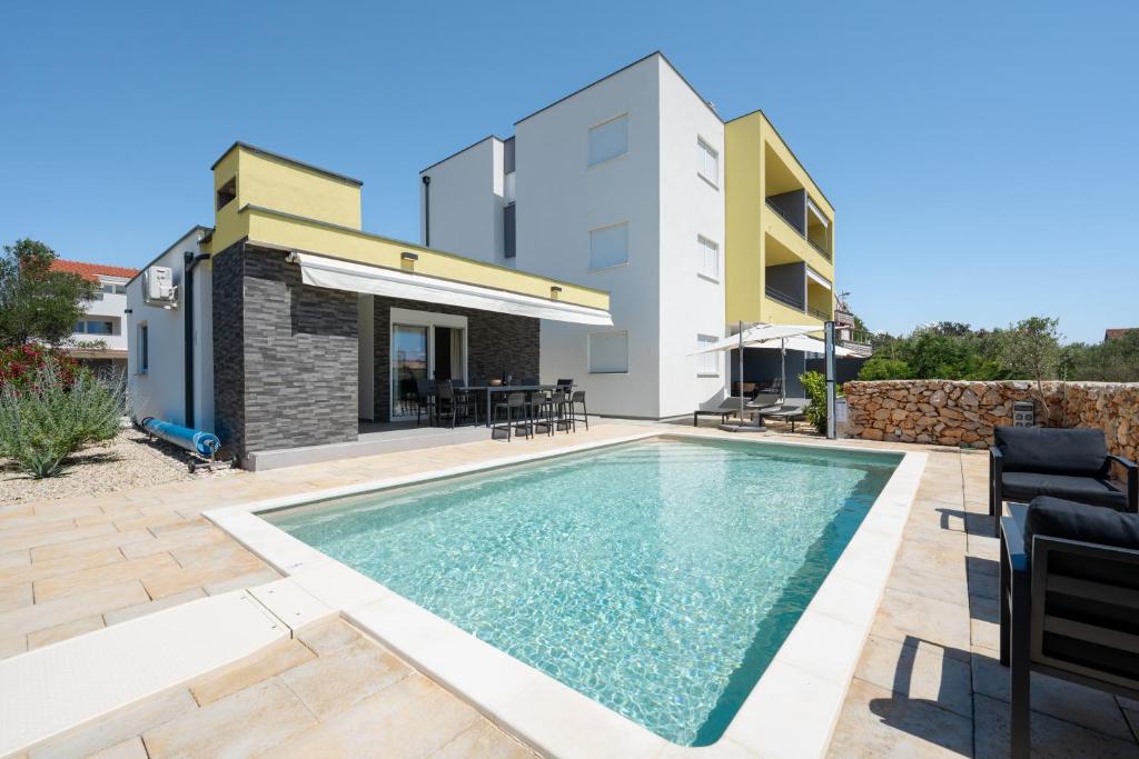 a swimming pool in the backyard of a house at Residence Giardino in Ugljan