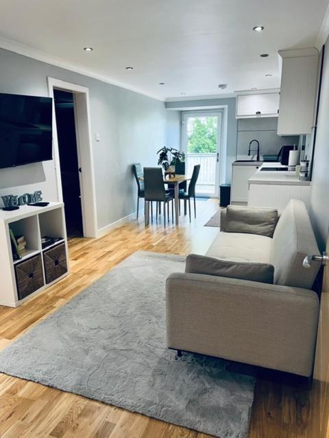 a living room with a couch and a kitchen at Whiteleys Cottages 2 bedroom in Renton