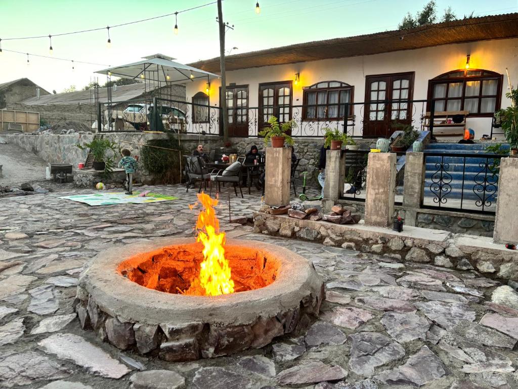 a fire pit in a courtyard in front of a building at Casona san isidro in Vicuña