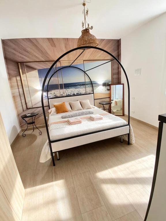 a bedroom with an iron canopy bed in a room at the Lighthouse accommodation in Taranto
