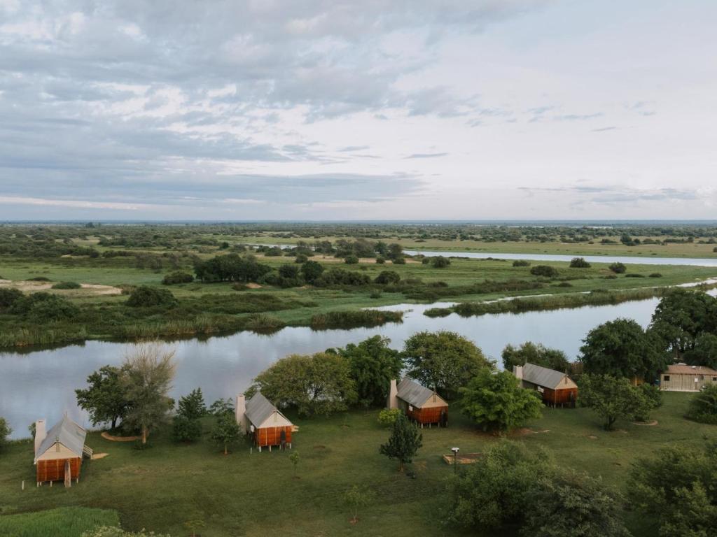 an aerial view of a group of tents next to a river at Muchenje River Lodge in Katima Mulilo